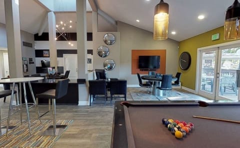 Community clubhouse with pool table, seating and lasing staff desk